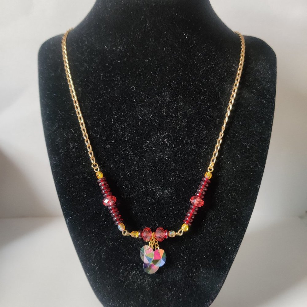 Gold tone chain necklace with interesting iridescent beads